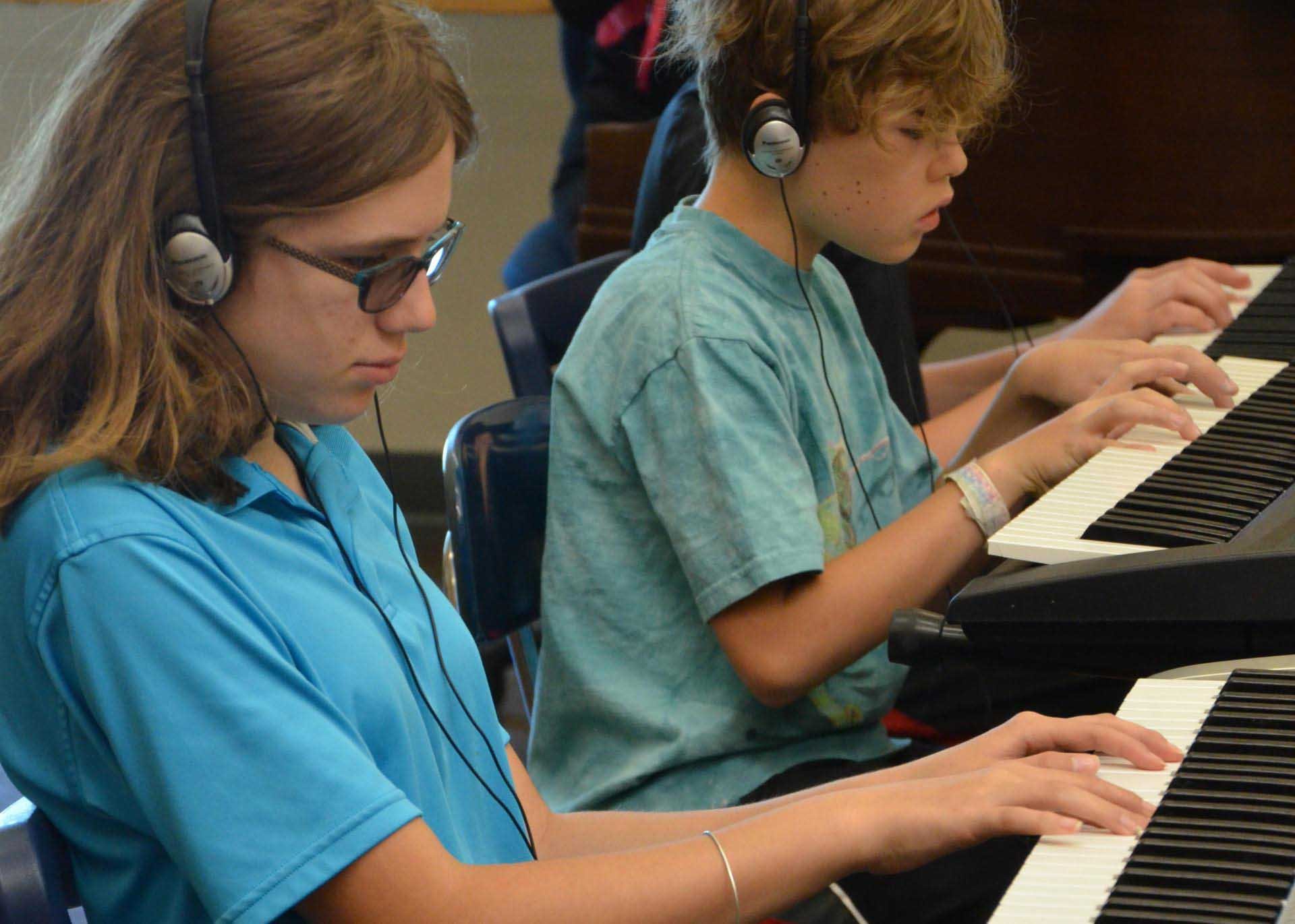 Campers playing piano keyboards