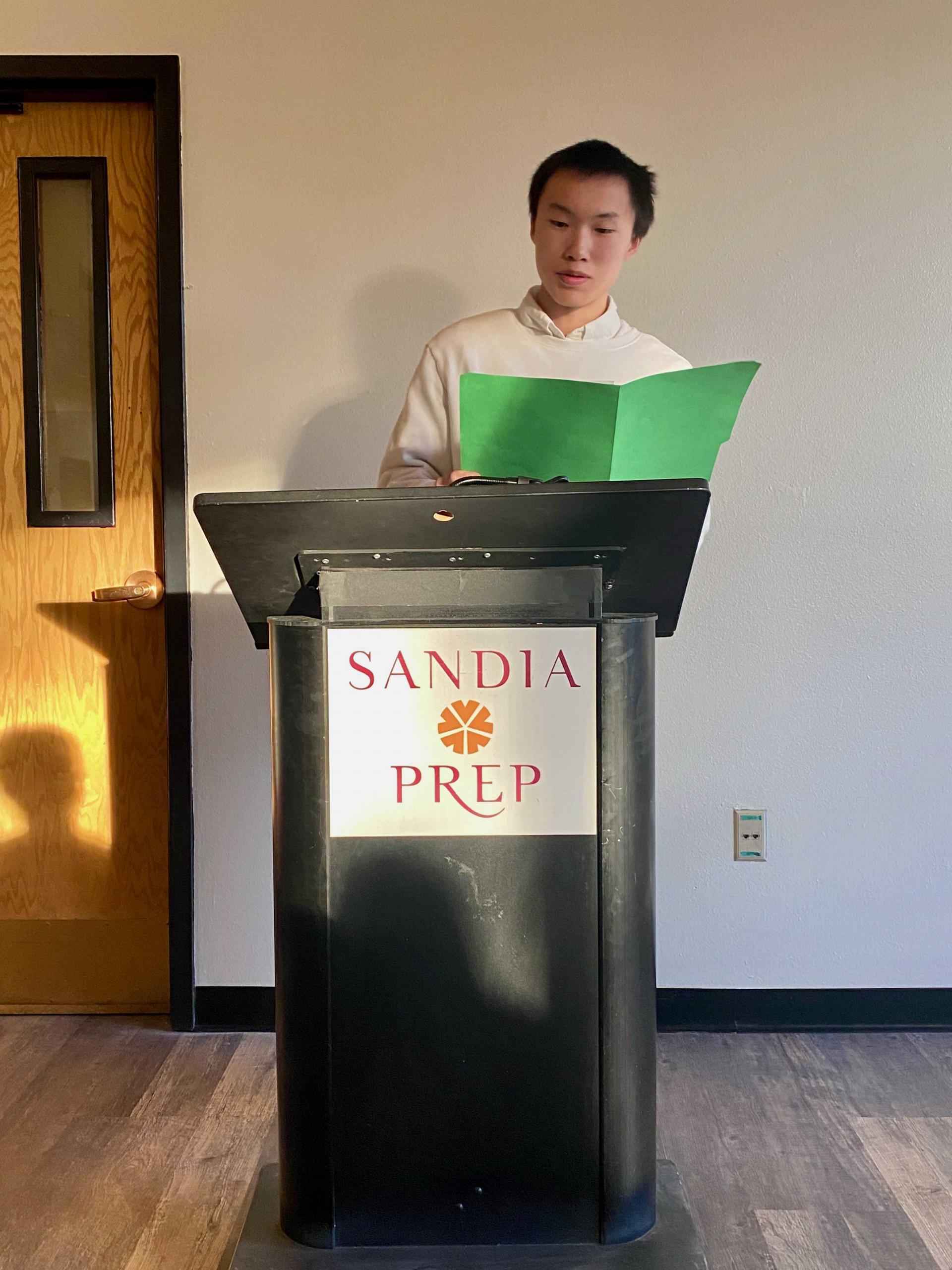 Odyssey Scholar presents research at podium