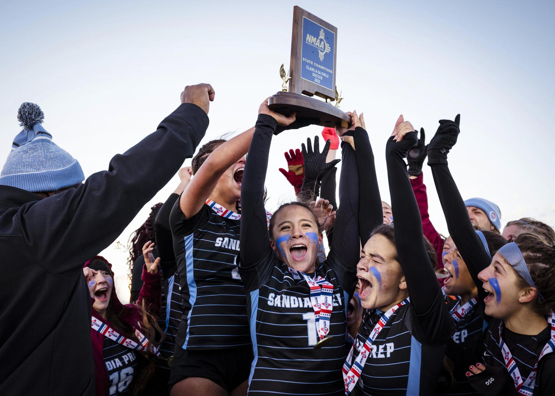 Girls soccer team hoists championship trophy