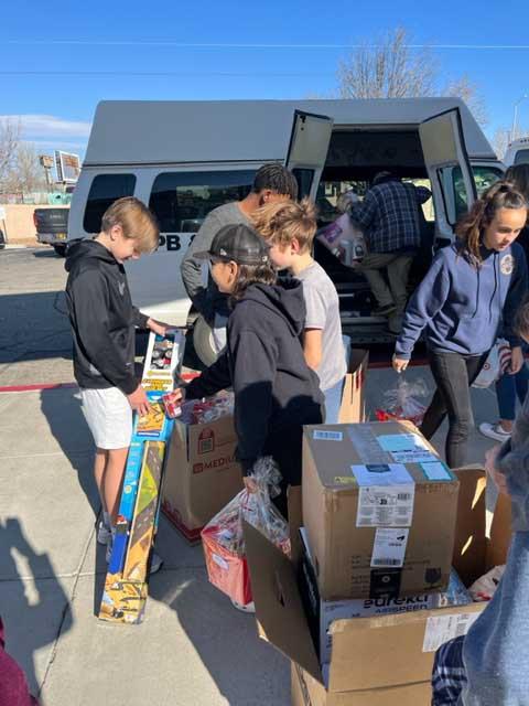 Students load items gathered for PB&J Family Services