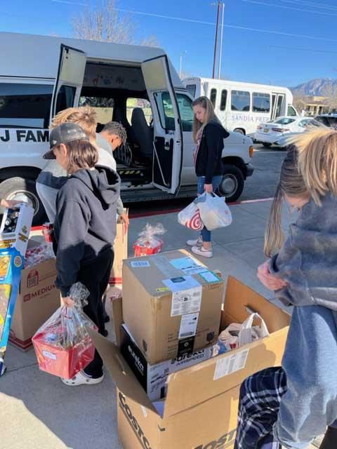 Students load items gathered for PB&J Family Services.