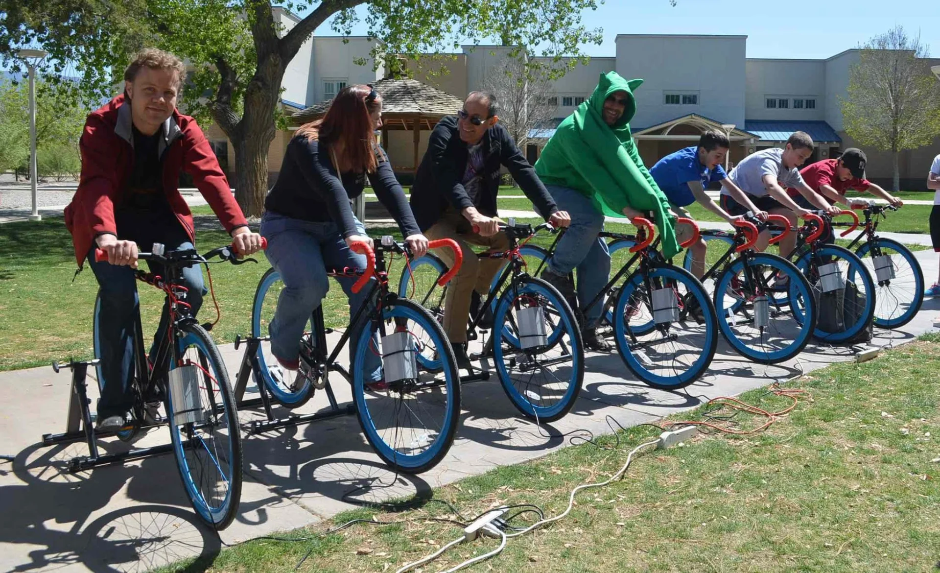 Dr. Chuck Buxbaum on bikes formerly used to generate electricity in the Russell Student Center.