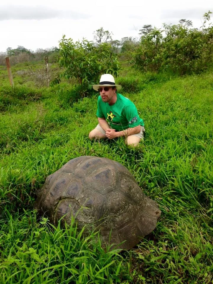 Dr. Chuck Buxbaum with a giant tortoise.