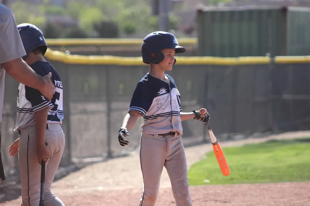 A young Logan Lemons playing baseball